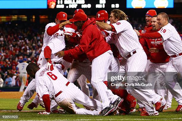 The Philadelphia Phillies pile on Jimmy Rollins after Rollins hit a game-winning walkoff 2-run double in the bottom of the ninth inning to win 5-4...