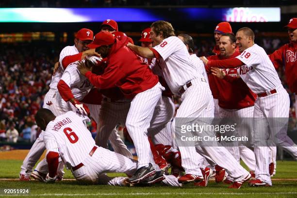 The Philadelphia Phillies pile on Jimmy Rollins after Rollins hit a game-winning walkoff 2-run double in the bottom of the ninth inning to win 5-4...