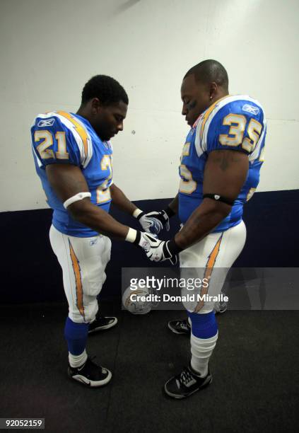 Runningback LaDainian Tomlinson and Fullback Mike Tolbert of the San Diego Chargers pray before the start of the game against the Denver Broncos...