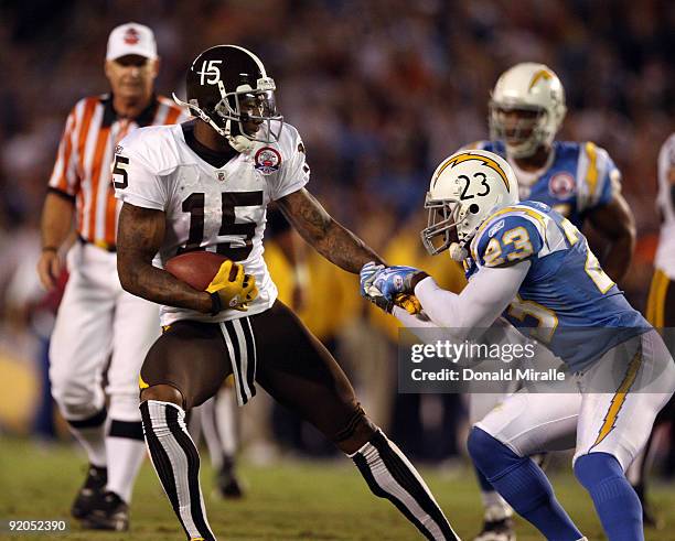 Wide Receiver Brandon Marshall of the Denver Broncos runs after the catch as Quentin Jammer of the San Diego Chargers holds on during Monday Night...