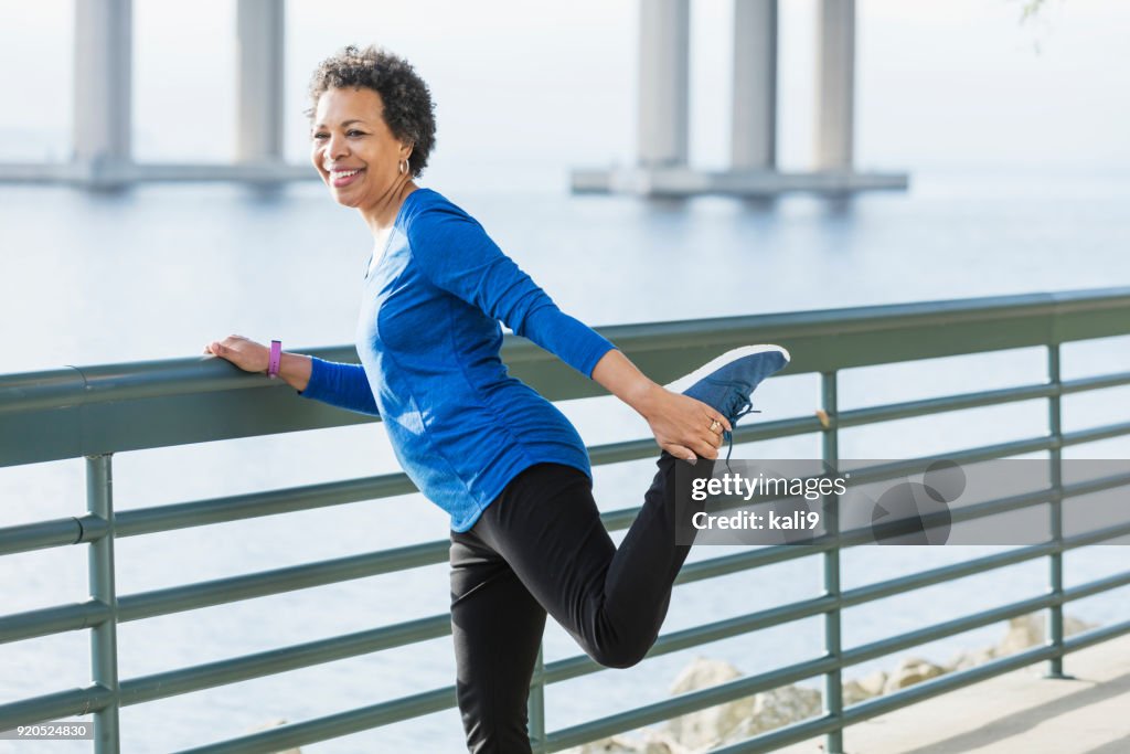 Mature African-American woman exercising on waterfront
