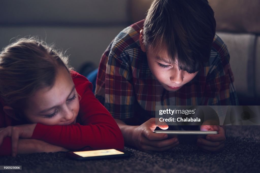 Girl and boy with their smart phones