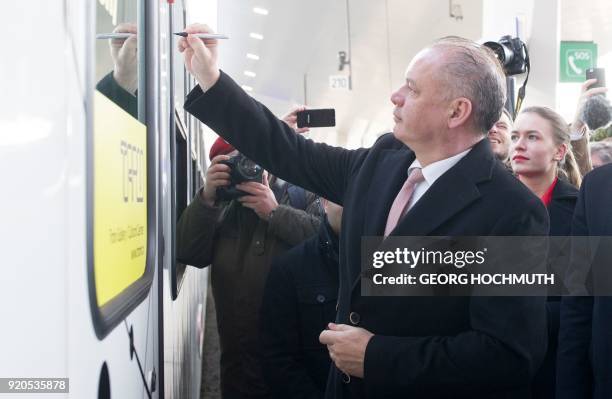 Slovakia's President Andrej Kiska signs a waggon at the main railway station prior to a meeting with Austria's President in Vienna, Austria, February...