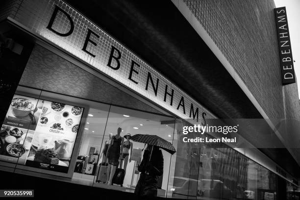Person holds an umbrella as they pass a branch of the Debenhams chain of department stores on Oxford Street on February 19, 2018 in London, England....