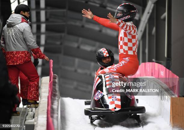 Croatia's Benedikt Nikpalj and Drazen Silic get out of the sled after the 2-man bobsleigh heat 3 run during the Pyeongchang 2018 Winter Olympic...