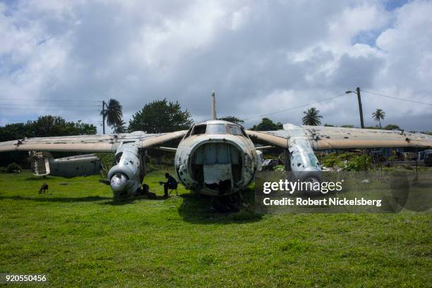 An inoperable Soviet-built Antonov 26 belonging to Cubana Airlines lies near the Pearls Airport runway February 10, 2018 in Saint Andrews, Grenada....