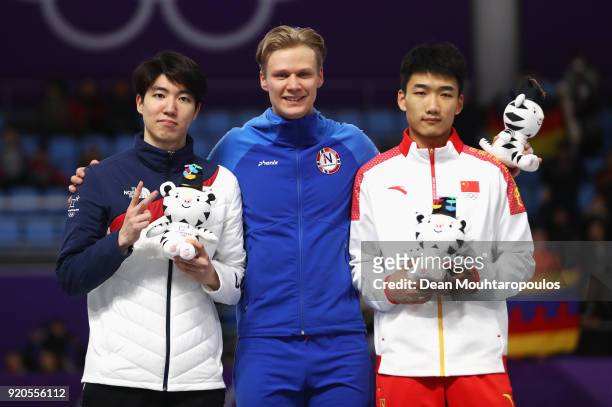 Silver medalist Min Kyu Cha of Korea, gold medalist Havard Lorentzen of Norway and bronze medalist Tingyu Gao of China stand on the podium during the...