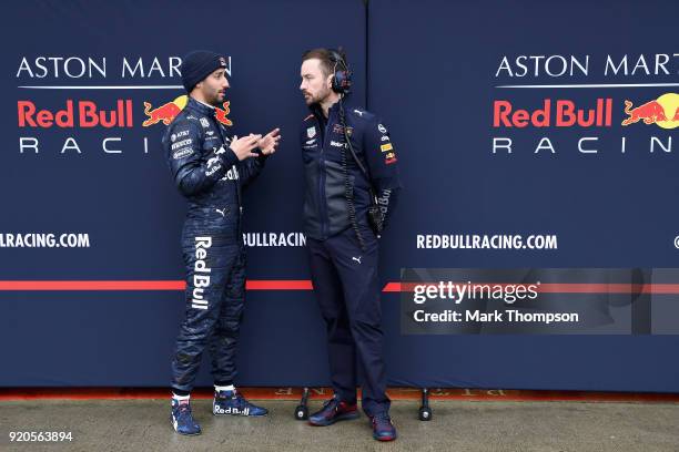 Daniel Ricciardo of Australia and Aston Martin Red Bull Racing talks with race engineer Simon Rennie outside the garage during the Aston Martin Red...