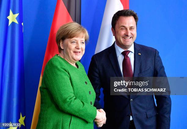 German Chancellor Angela Merkel shakes hands with Luxembourg's Prime Minister Xavier Bettel at the end of a press conference at the Chancellery in...