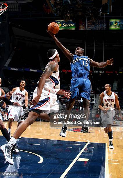 Mike James of the Washington Wizards puts up a shot over Jeff Teague of the Atlanta Hawks during a preseason game on October 19, 2009 at Philips...