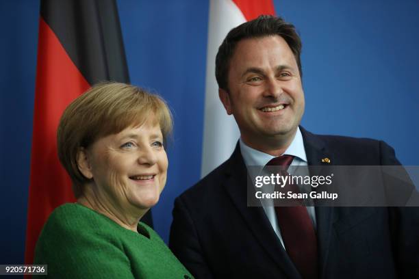 German Chancellor Angela Merkel and Luxembourg Prime Minister Xavier Bettel depart after giving statements to the media following talks at the...