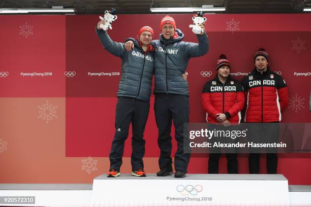 Joint gold medalists Francesco Friedrich and Thorsten Margis of Germany and Justin Kripps and Alexander Kopacz of Canada celebrate during the victory...