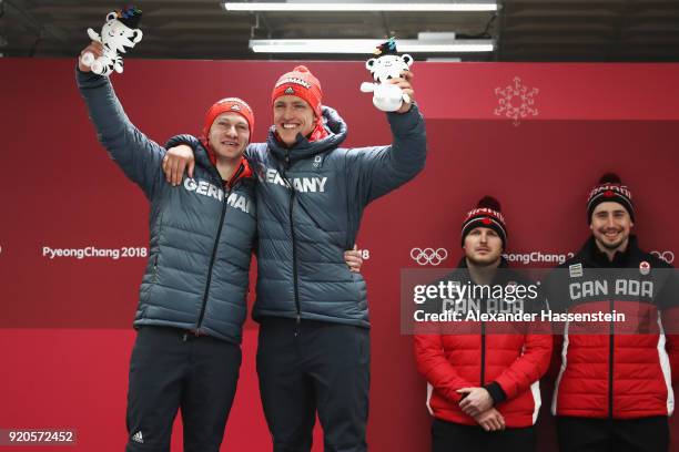 Joint gold medalists Francesco Friedrich and Thorsten Margis of Germany and Justin Kripps and Alexander Kopacz of Canada celebrate during the victory...