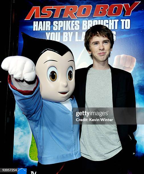 Actor Freddie Highmore poses with Astro Boy at the premiere of Summit Entertainment and Imagi Studios' "Astro Boy" at the Chinese Theater on October...
