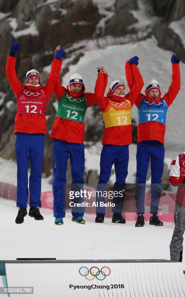 Winners of the gold, Daniel Andre Tande, Andreas Stjernen, Johann Andre Forfang and Robert Johansson of Norway celebrate on the podium following the...