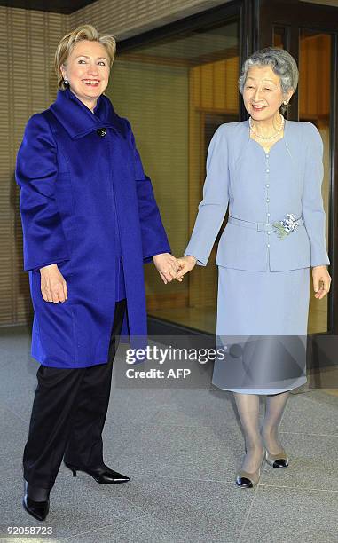 Visiting US Secretary of State Hillary Clinton is greeted by Japanese Empress Michiko for their tea party at the Imperial residence in Tokyo on...
