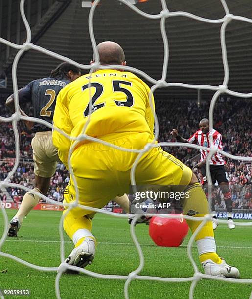 Sunderland's English forward Darren Bent shoots and his shot hits a red beach-ball and deflects past Liverpool's Spanish goalkeeper Pepe Reina into...