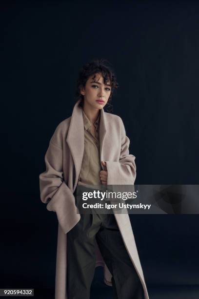 young beautiful woman on dark background - high fashion stock pictures, royalty-free photos & images