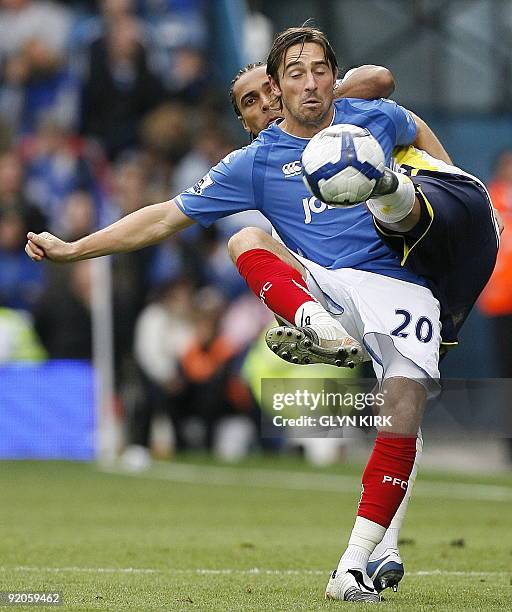 Tottenham Hotspur's French-Cameroonian defender Benoit Assou-Ekotto vies with Portsmouth's English striker Tommy Smith during the Premier League...