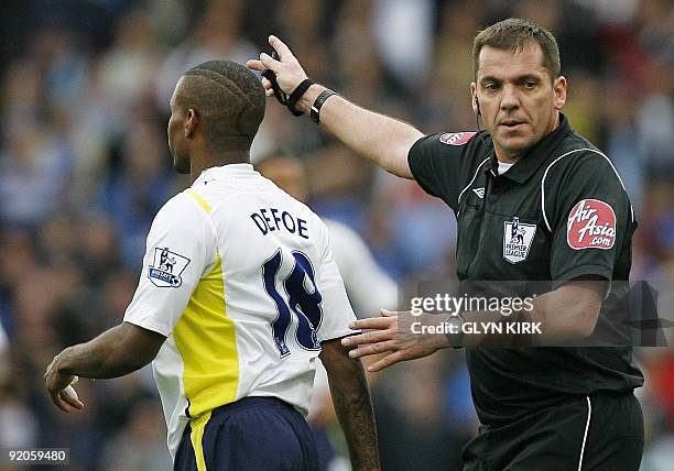 Tottenham Hotspur's English striker Jermain Defoe is sent off by referee Phil Dowd during the English Premier League football match between...