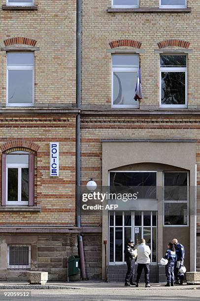 French police agents discuss on October 20, 2009 in front of the police building in Mulhouse , where Frenchman Andre Bamberski father of Kalinka...