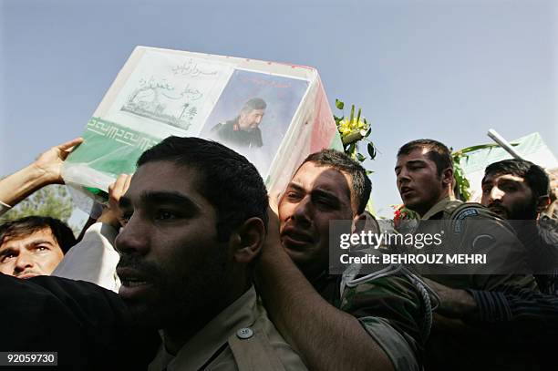 Iranians carry the coffin of Rajabali Mohammadzadeh, a commander of the Revolutionary Guards ground forces, killed two days ago, near the Pakistani...