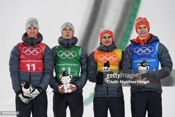 Karl Geiger, Stephan Leyhe, Richard Freitag and Andreas Wellinger of Germany celebrate their silver medal on the podium during the Ski Jumping -...
