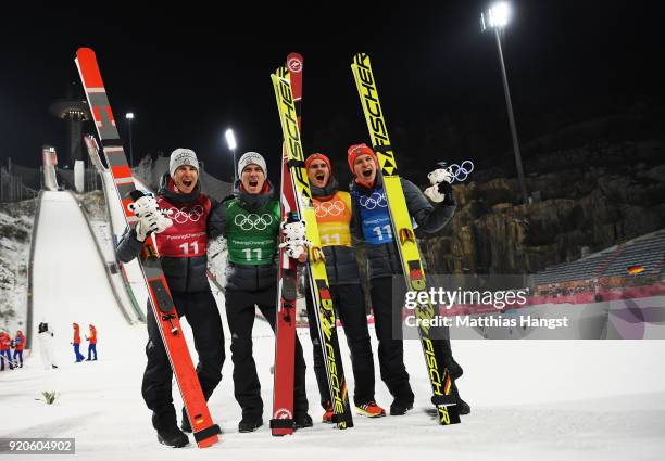 Karl Geiger, Stephan Leyhe, Richard Freitag and Andreas Wellinger of Germany celebrate their silver medal on the podium during the Ski Jumping -...