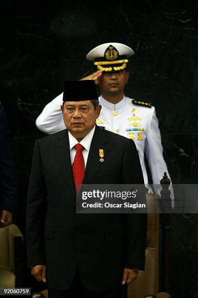 Indonesian President Susilo Bambang Yudhoyono stands for the National Anthem during his Inauguration ceremony at the House of Representative building...