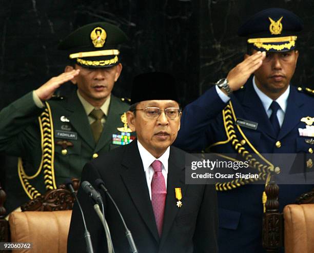 Vice President Boediono sings the National Anthem during the Inauguration ceremony for himself as Vice President and President Yudhoyono at the House...