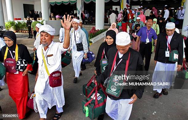 Thai Muslim Hajj pilgrim waves as he leaves for Mecca at Hat Yai International airport, southern Thailand, on October 20, 2009. A batch of hundreds...