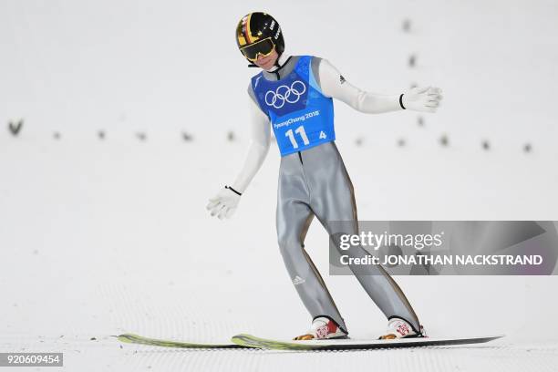 Germany's Andreas Wellinger reacts after his jump to clinch silver for his team in the men's large hill team ski jumping final round event during the...