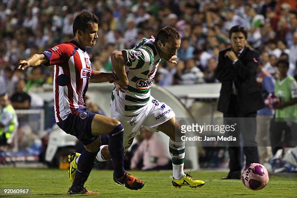 Chivas' Aaron Galindo vies for the ball with Santos' Matias Vuoso during their match in the Apertura 2009 tournament, the Mexican Football League, at...
