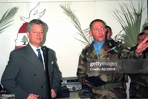 French Defense Minister Alain Richard listens 01 January to French colonel G. Genet during his visit to the United Nations headquarters in Naqura in...