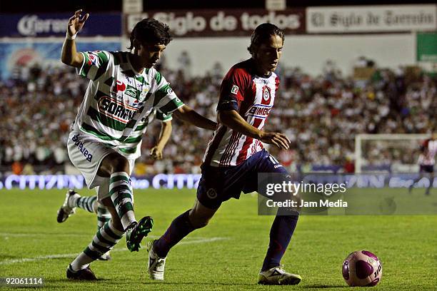 Santos' Uriel Alvarez vies for the ball with Chivas' Edgar Ivan Solis during their match in the Apertura 2009 tournament, the Mexican Football...