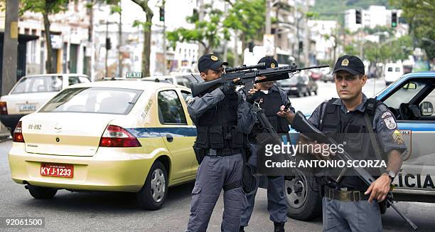 Rio de Janeiro special force police officer points his gun in search of drug traffickers at Morro dos Macacos shantytown , on October 20, 2009. More...