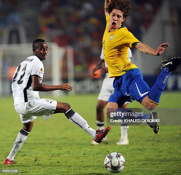 Ghana's Ghandy Kassenu tries to stop Brazil's Renan as he prepares to kick the ball during their FIFA U-20 World Cup final match in Cairo on October...