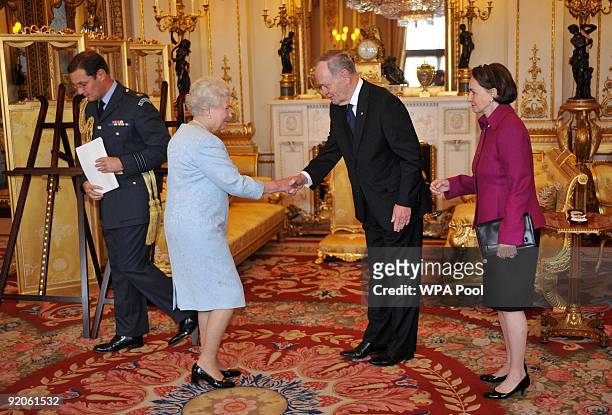 Britain's Queen Elizabeth II receives Former Canadian Prime Minister Jean Chretien, accompanied by wife his Aline, before presenting him with the...