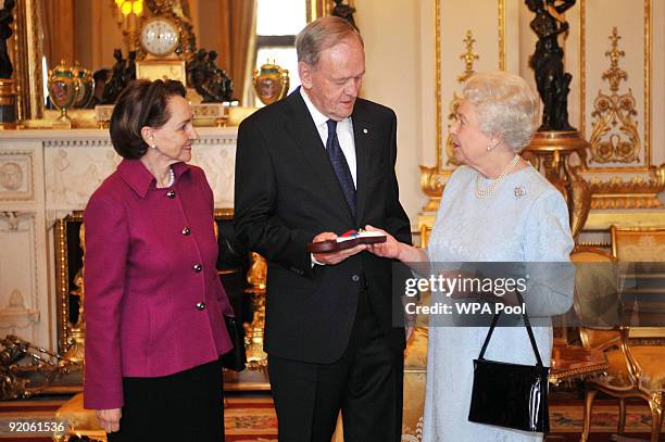 Britain's Queen Elizabeth II presents the Order of Merit to Former Canadian Prime Minister Jean Chretien who is accompanied by wife Aline at...