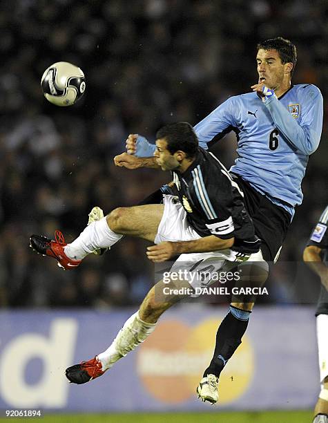 Argentine midfielder Javier Mascherano vies for the ball with Uruguay's defender Andres Scotti during their FIFA World Cup South Africa-2010...
