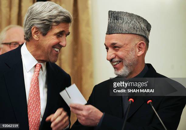 Senator John Kerry laugh with Afghan President Hamid Karzai at a press conference at the presidential palace in Kabul on October 20, 2009. Karzai...