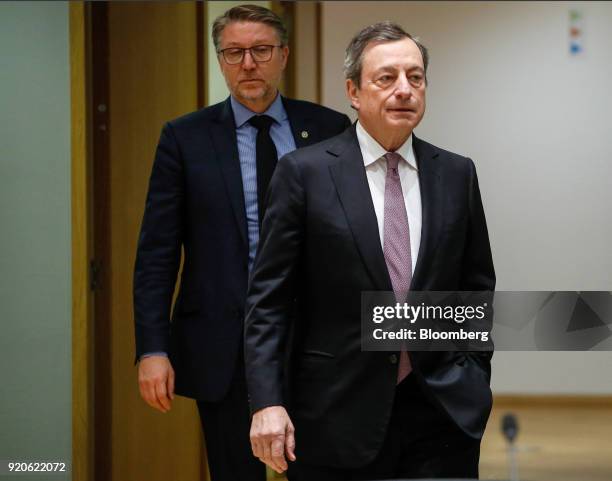 Mario Draghi, president of the European Central Bank , right, arrives for a Eurogroup finance ministers meeting in Brussels, Belgium, on Monday, Feb...