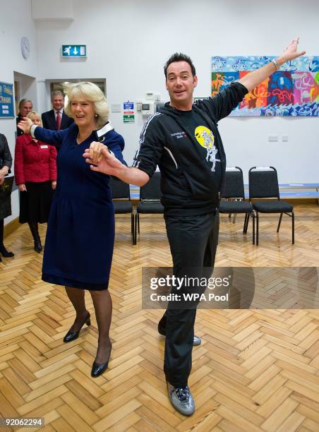 President of the National Osteoporosis Society Camilla, Duchess of Cornwall and Craig Revel Horwood dance the Cha-Cha-Cha during a visit to St...