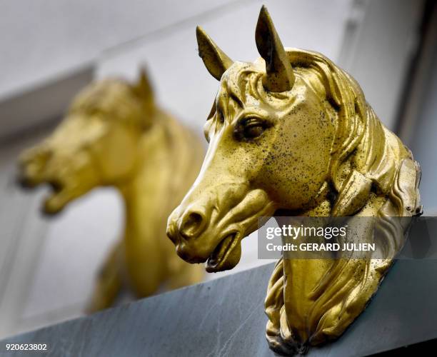 This picture taken on February 19, 2018 shows metal horse heads above a horsemeat butcher in Vincennes, near Paris. / AFP PHOTO / GERARD JULIEN