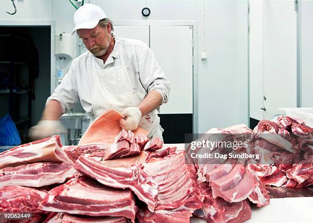 butcher in local abattoir with ecological meat - slaughterhouse stock pictures, royalty-free photos & images