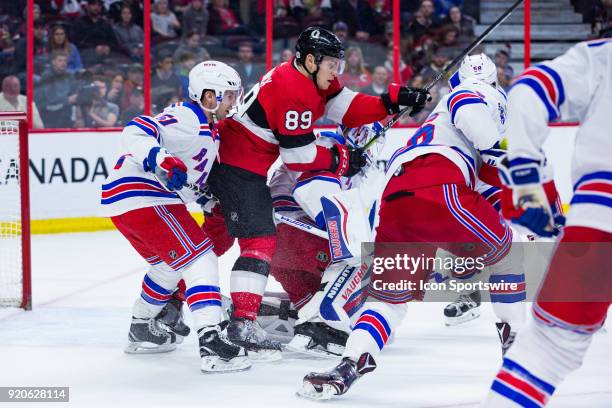 Ottawa Senators Left Wing Max McCormick crashes through the crease as he battles New York Rangers Center David Desharnais during third period...