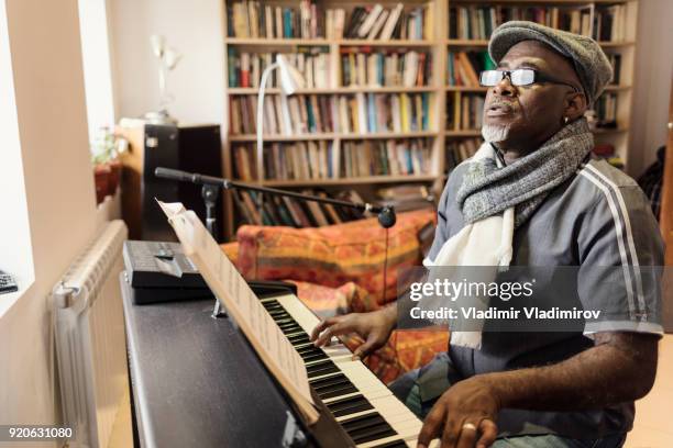 african man playing the piano - music rehearsal stock pictures, royalty-free photos & images