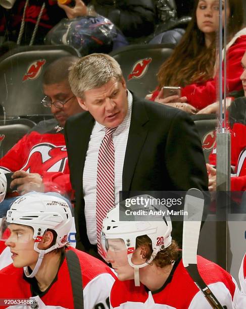 Head coach Bill Peters of the Carolina Hurricanes looks on during the game against the New Jersey Devils at Prudential Center on February 15, 2018 in...