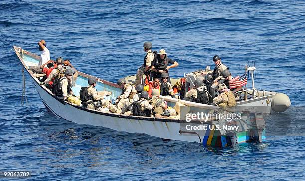 In this photo provided by the U.S. Navy, Members of a visit, board, search and seizure team from the guided-missile cruiser USS Anzio and U.S. Coast...