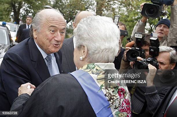 The President of the FIFA Sepp Blatter greets Erzsebet, the widow of the legendary footballer Ferenc Puskas, in the Puskas Ferenc Football Academy in...